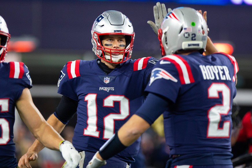 New England Patriots quarterback Tom Brady (12) gets a high five from quarterback Brian Hoyer (2) after Brady threw a touchdown pass in the fourth quarter against the Green Bay Packers at Gillette Sta ...