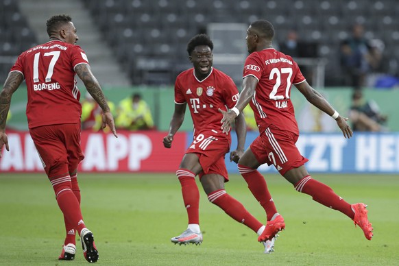 Bayern&#039;s David Alaba, right, celebrates after scoring his side&#039;s first goal during the German soccer cup (DFB Pokal) final match between Bayer 04 Leverkusen and FC Bayern Munich in Berlin, G ...