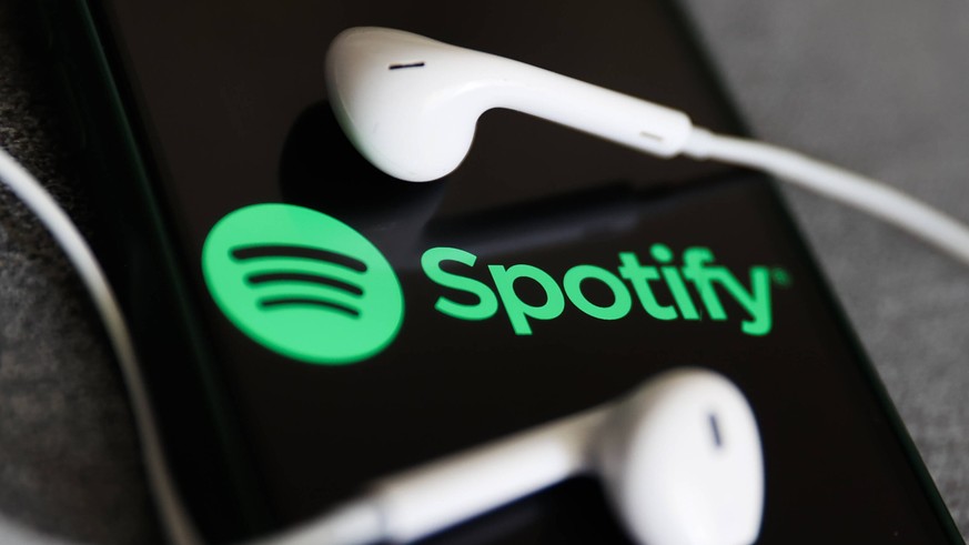 Spotify And Heardle Photo Illustrations Spotify logo displayed on a phone screen and headphones are seen in this illustration photo taken in Krakow, Poland on July 12, 2022. Krakow Poland PUBLICATIONx ...