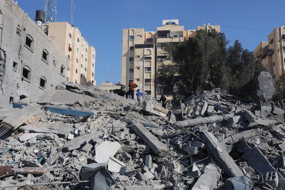 Palestinians searche in the ruins of a building in the aftermath of an overnight Israeli bombing in Nuseirat Palestinians searche in the ruins of a building in the aftermath of an overnight Israeli bo ...