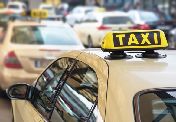 taxi sign on top of a car