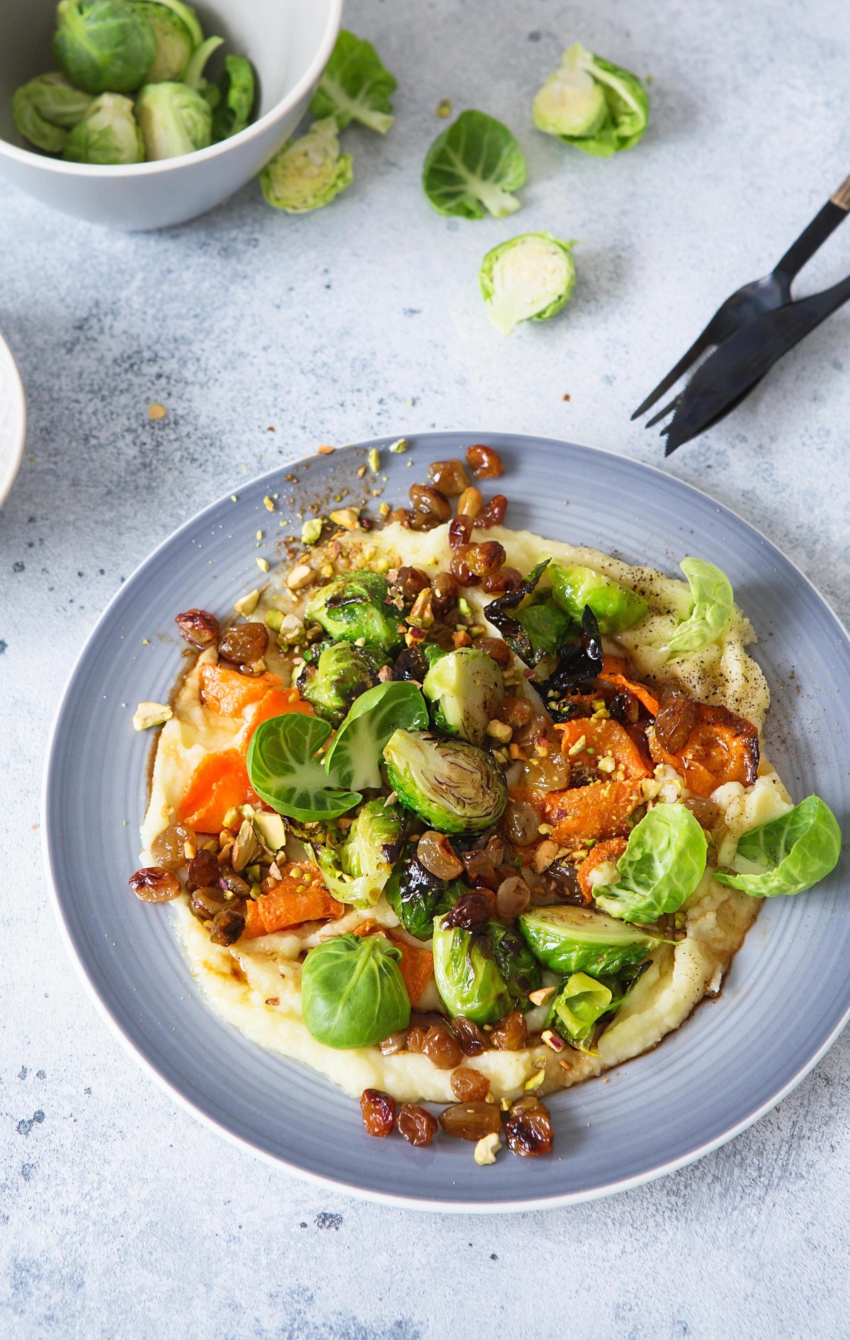 Brussels sprouts with pistachios, raisins and Skordalia (mashed potatoes). Healthy Meal preparation. Plant-based dishes. Green living. Vegan recipe. Food styling. Vegetarian cuisine. Healthy eating