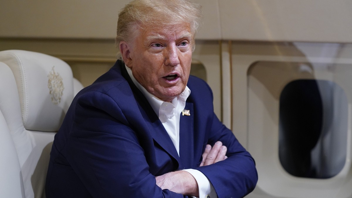 FILE - Former President Donald Trump speaks with reporters while in flight on his plane after a campaign rally at Waco Regional Airport, in Waco, Texas, March 25, 2023, while en route to West Palm Bea ...