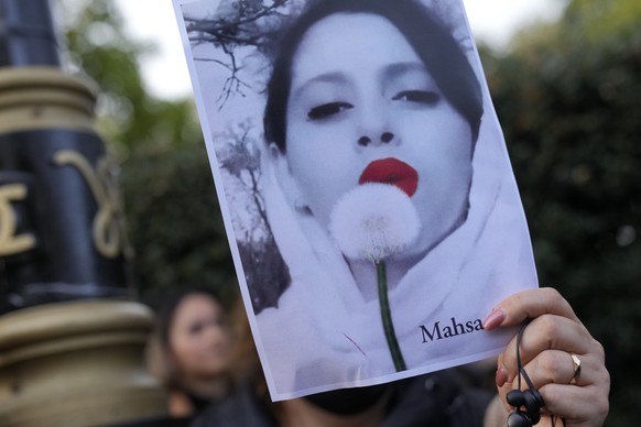 Demonstrators hold placards outside the Iranian Embassy in London, Sunday, Sept. 25, 2022. They were protesting against the death of Iranian Mahsa Amini, a 22-year-old woman who died in Iran while in  ...