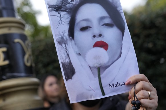 Demonstrators hold placards outside the Iranian Embassy in London, Sunday, Sept. 25, 2022. They were protesting against the death of Iranian Mahsa Amini, a 22-year-old woman who died in Iran while in ...