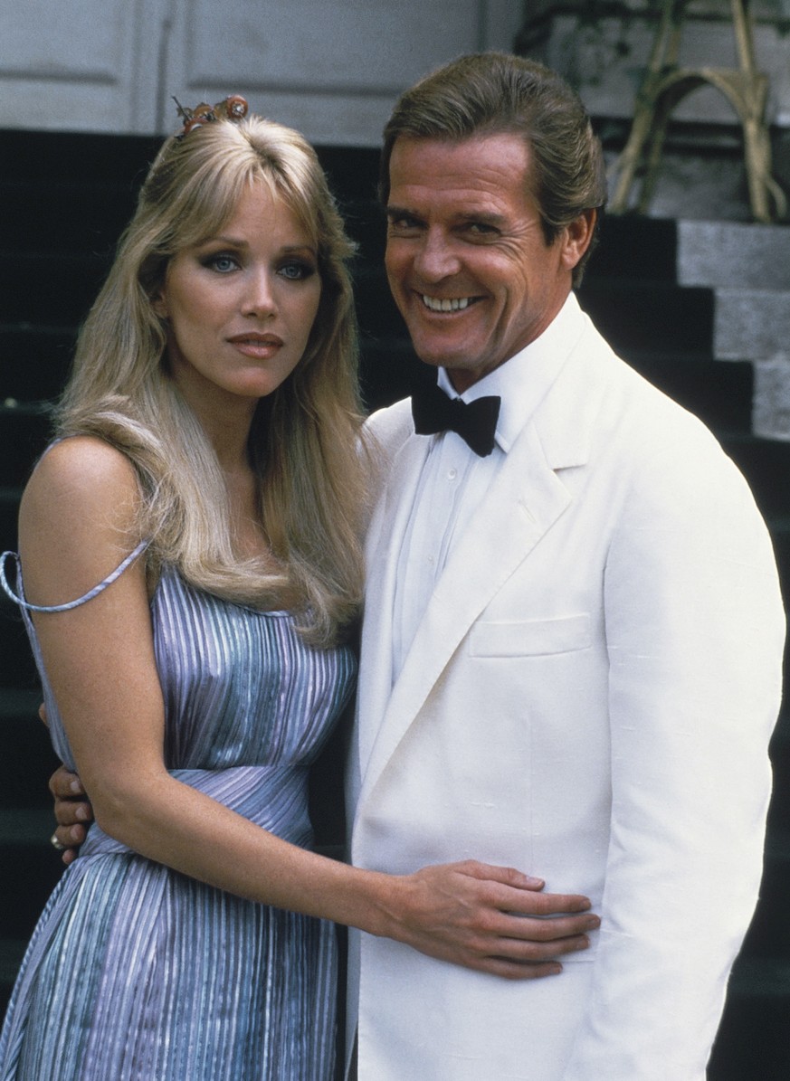 FILE - Actor Roger Moore, right, poses with his co-star Tanya Roberts from the James Bond film &quot;A View to a Kill,&quot; outside of Château de Chantilly in Chantilly, France on Aug. 17, 1984. Robe ...