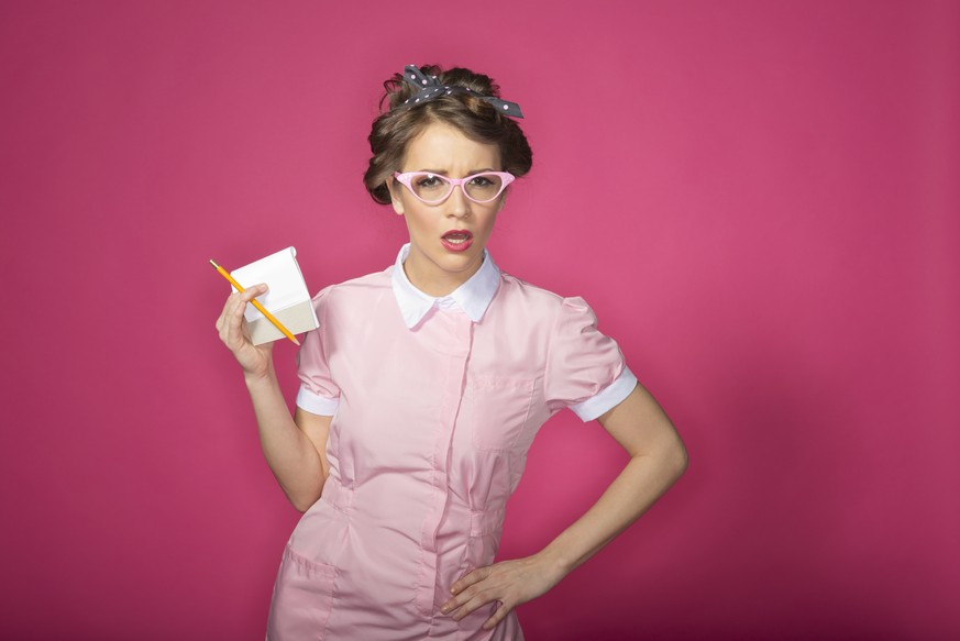 A retro waitress holding a pad