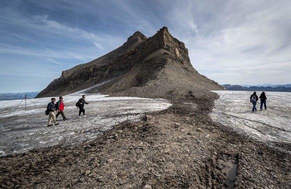 This picture taken on September 13, 2022 at the Glacier 3000 resort above Les Diablerets shows tourists walking on the Tsanfleuron pass free of the ice that covered it for at least 2,000 years. - The  ...