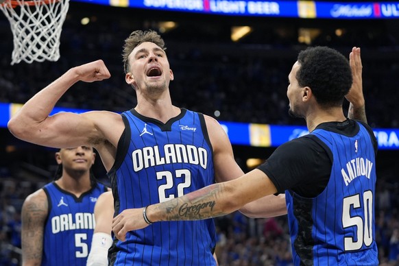 Orlando Magic forward Franz Wagner (22) celebrates with guard Cole Anthony (50) after making a basket and drawing a foul against the Cleveland Cavaliers during the second half of Game 4 of an NBA bask ...