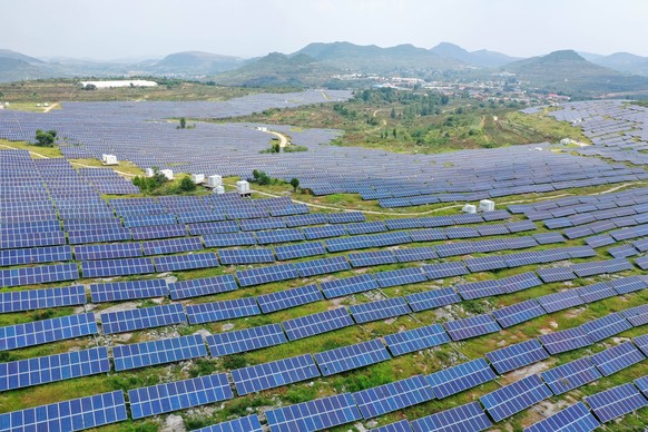 Solar Energy ZAOZHUANG, CHINA - AUGUST 16, 2023 - Blue photovoltaic panels on a barren mountain generate clean electricity under sunlight in Zaozhuang city, Shandong province, China, August 16, 2023.  ...