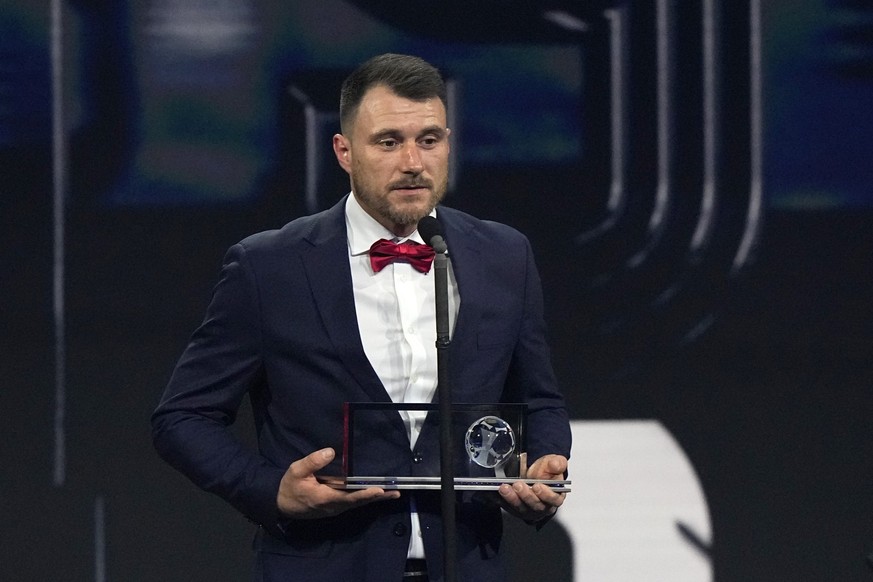 Polish amputee soccer player Marcin Oleksy speaks after receives the FIFA Puskas Award for the best goal during the ceremony of the Best FIFA Football Awards in Paris, France, Monday, Feb. 27, 2023. ( ...