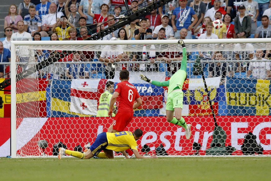 Football: England vs Sweden at World Cup England goalkeeper John Pickford (far back) saves the ball from Marcus Berg (front) of Sweden during the second half of a World Cup quarterfinal between the tw ...