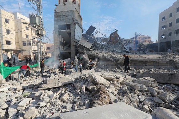 Palestinians inspect the wreckage following an Israeli air strike on the Jaffa Mosque and Hospital in Dair El-Balah Palestinians inspect the wreckage following an Israeli air strike on the Jaffa Mosqu ...