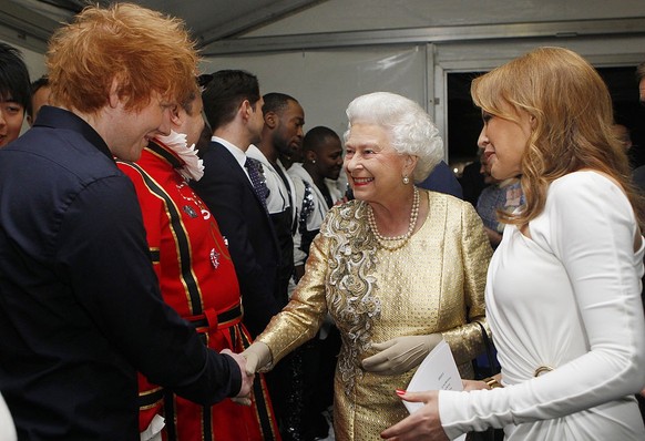 LONDON, ENGLAND - JUNE 04: Queen Elizabeth II is introduced to Ed Sheeran (L) by Kylie Minogue backstage after the Diamond Jubilee, Buckingham Palace Concert on June 04, 2012 in London, England. For o ...