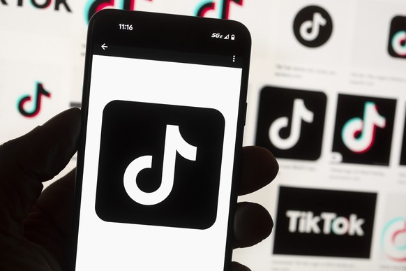 FILE - The TikTok logo is seen on a cell phone on Oct. 14, 2022, in Boston. On Thursday, Jan. 12, 2023, Wisconsin became the latest state to ban the use of TikTok on state phones and other devices, a  ...