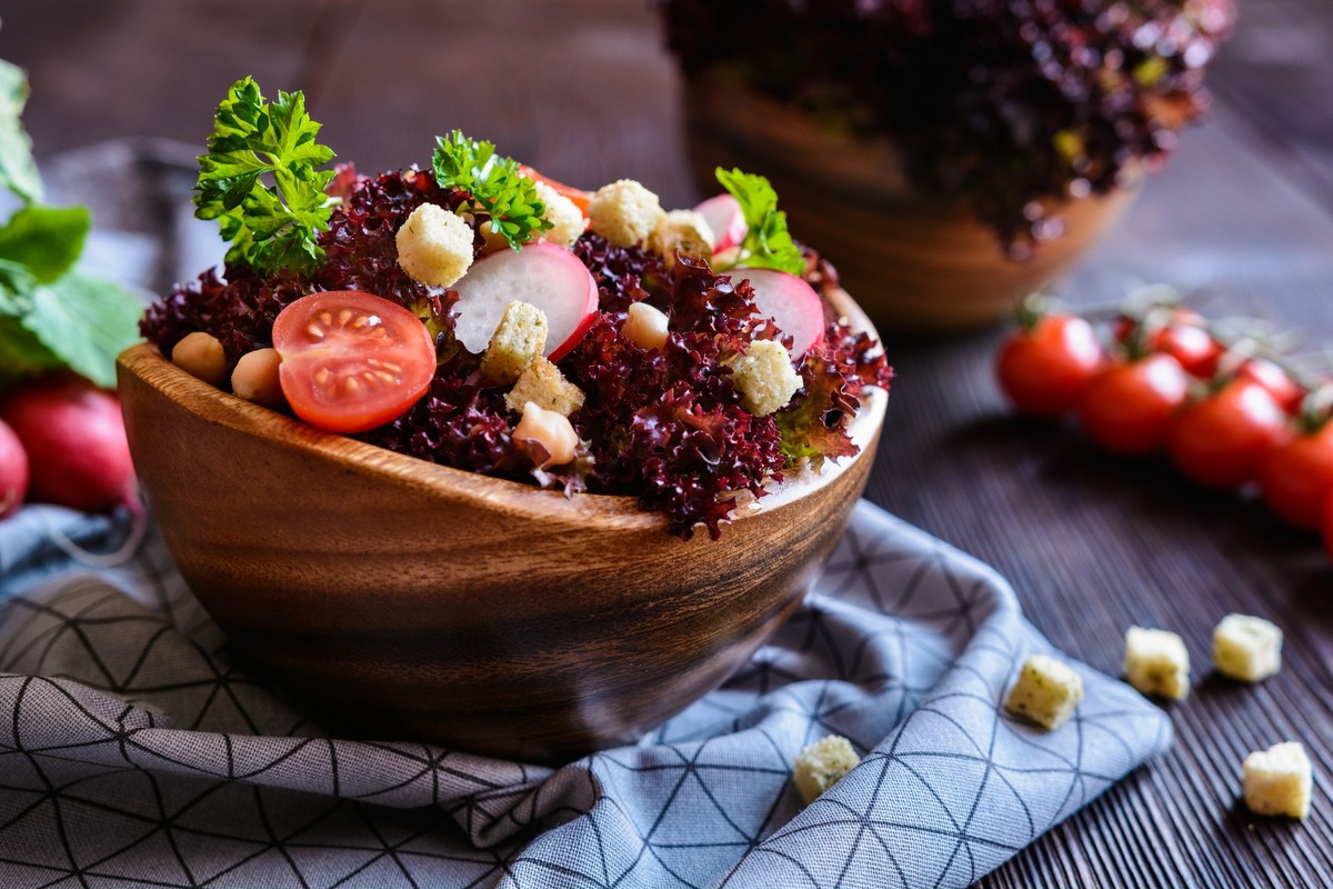 Fresh Lollo Rosso salad with chickpeas, tomato, radish and croutons