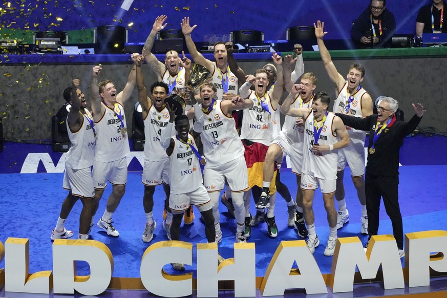 Germany celebrates with the trophy after winning the championship game of the Basketball World Cup against Serbia in Manila, Philippines, Sunday, Sept. 10, 2023. (AP Photo/Aaron Favila)