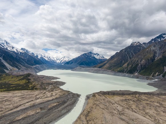 Stunning high angle aerial drone view of Tasman Lake, a proglacial lake formed by the recent retreat of the Tasman Glacier, part of Aoraki/Mount Cook National Park on New Zealand&#039;s South Island.