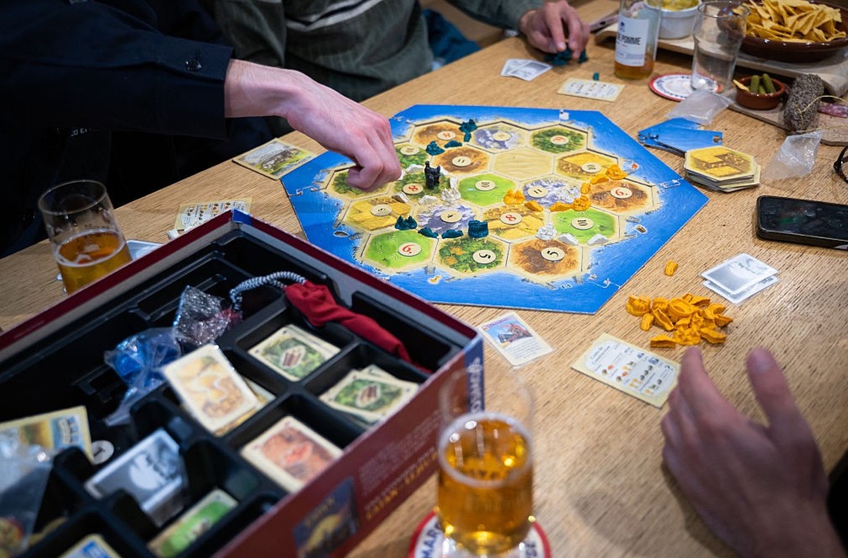Clients play a board game named &quot;Catan&quot; in a games bar in Paris on May 21, 2025. (Photo by Leo VIGNAL / AFP) (Photo by LEO VIGNAL/AFP via Getty Images)