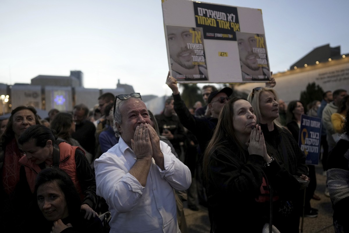 Relatives and friends of people killed and abducted by Hamas and taken into Gaza, react as they gather in Tel Aviv, Israel on Sunday, Jan. 19, 2025. (AP Photo/Oded Balilty)