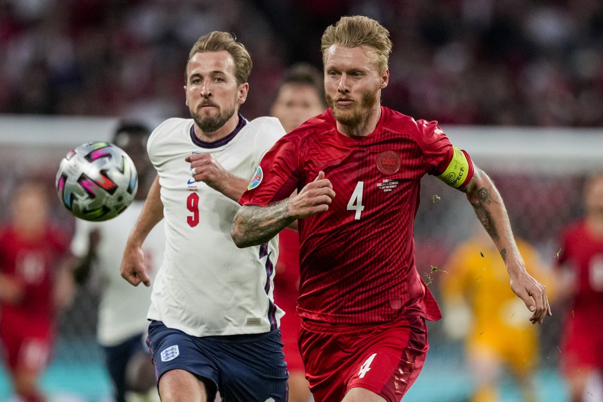 Denmark&#039;s Simon Kjaer, right, and England&#039;s Harry Kane run for the ball during the Euro 2020 soccer championship semifinal match between England and Denmark at Wembley stadium in London, Wed ...