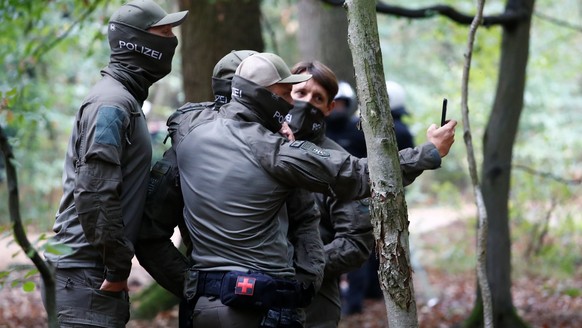 Police officers make a selfie as they prepare to clear the area at the &quot;Hambacher Forst&quot; in Kerpen-Buir near Cologne, Germany, September 13, 2018, where protesters have built a camp with ten ...