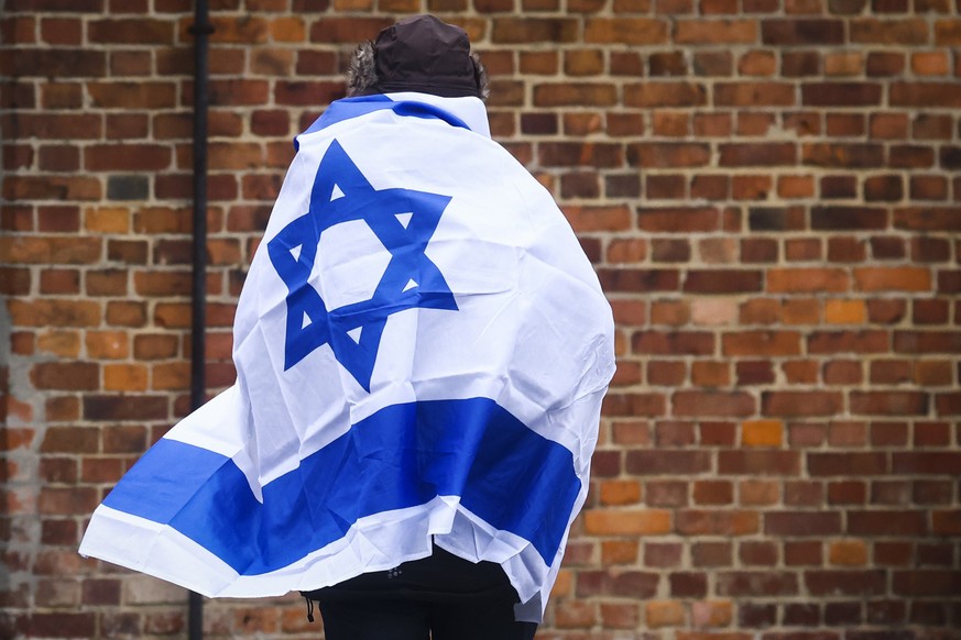 A man with Israeli flag is seen during the 78th Anniversary Of Auschwitz - Birkenau Liberation ceremony and International Holocaust Remembrance Day in the former Nazi German concentration and extermin ...