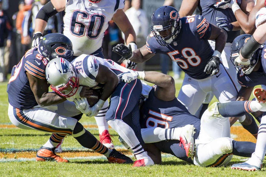 October 21, 2018: Chicago, Illinois, U.S. - Bears 91 Eddie Goldman tackles Patriots 38 Kenjon Barner during the NFL American Football Herren USA Game between the New England Patriots and Chicago Bears ...