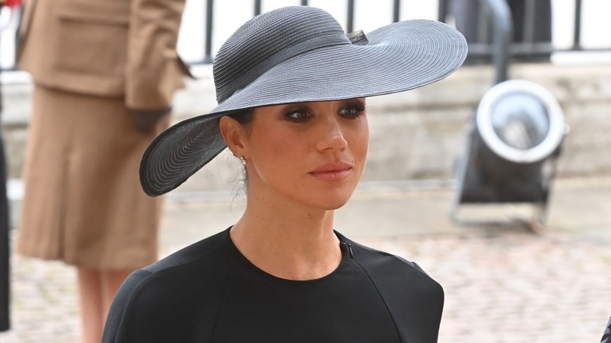 LONDON, ENGLAND - SEPTEMBER 19: Meghan, Duchess of Sussex walks behind The Queen&#039;s funeral cortege borne on the State Gun Carriage of the Royal Navy as it proceeds towards Westminster Abbey on Se ...