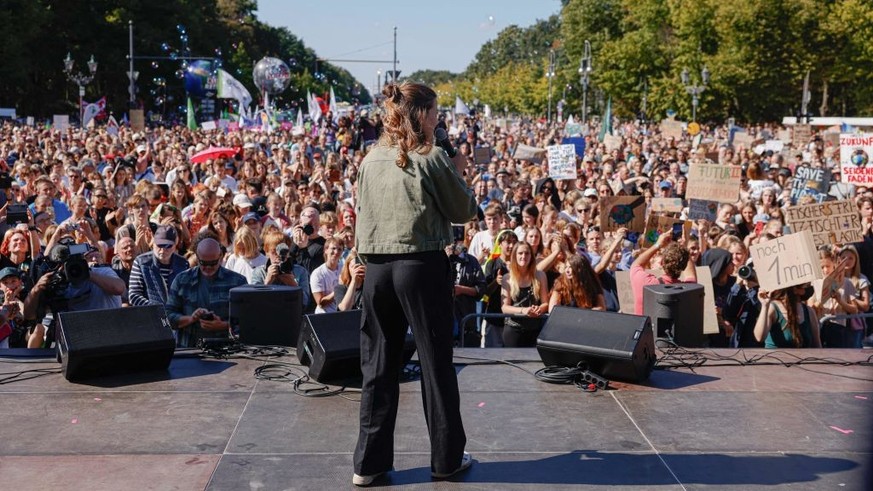 German climate activist Luisa Neubauer speaks on stage during a protest of the Fridays for Future movement and other activists at the Brandenburg Gate in Berlin on September 15, 2023. (Photo by Odd AN ...