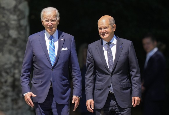 FILE - German Chancellor Olaf Scholz, right, and U.S. President Joe Biden, arrive for the official G7 summit welcome ceremony at Castle Elmau in Kruen, near Garmisch-Partenkirchen, Germany, June 26, 2 ...