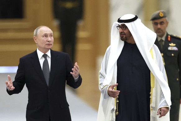 06.12.2023, Vereinigte Arabische Emirate, Abu Dhabi: Dieses von der staatlichen russischen Nachrichtenagentur Sputnik via AP veröffentlichte Foto zeigt Mohammed bin Zayid Al Nahyan (r), Präsident der  ...