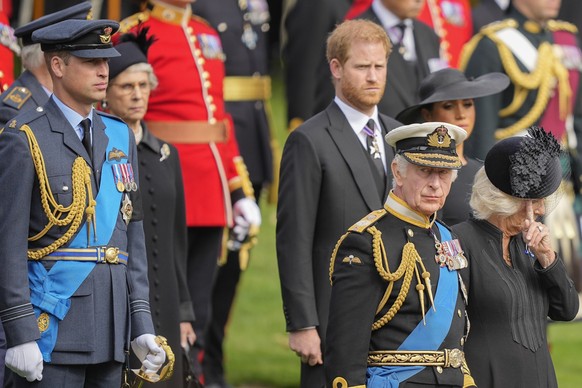 King Charles III, from right, Camilla, the Queen Consort, Meghan, Duchess of Sussex, Prince Harry and Prince William watch as the coffin of Queen Elizabeth II is placed into the hearse following the s ...