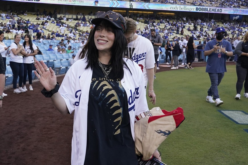 Singer Billie Eilish waves to fans before a baseball game between the Los Angeles Dodgers and the San Francisco Giants on Thursday, July 21, 2022, in Los Angeles. (AP Photo/Marcio Jose Sanchez)