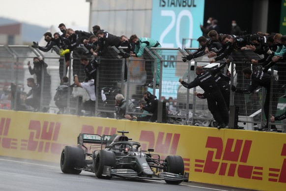 Mercedes driver Lewis Hamilton of Britain crosses the finish line to win the Formula One Turkish Grand Prix at the Istanbul Park circuit racetrack in Istanbul, Sunday, Nov. 15, 2020. (Tolga Bozoglu/Po ...