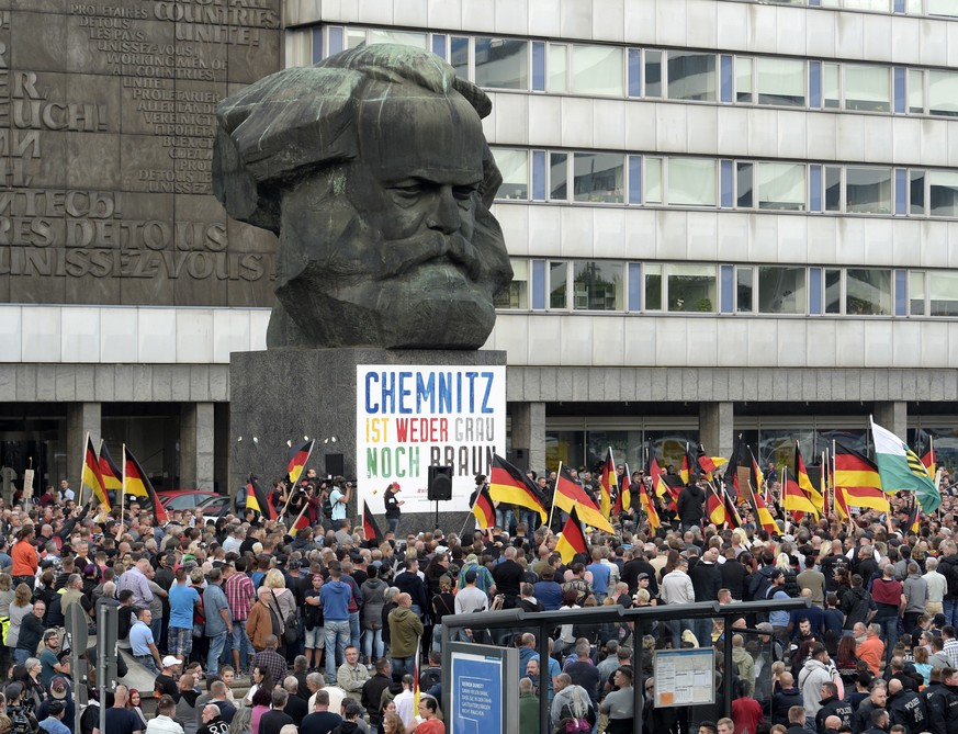People attend a demonstration in Chemnitz, eastern Germany, Friday, Sept.7, 2018, after several nationalist groups called for marches protesting the killing of a German man two weeks ago, allegedly by ...
