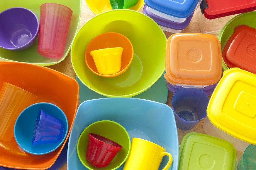 Top view of lots of plastic kitchen utensils, mostly containers