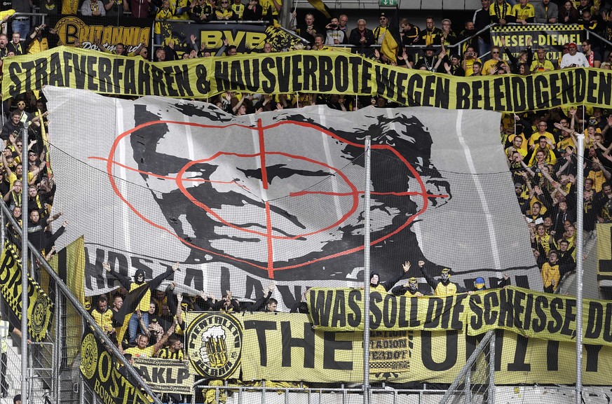 Dortmund fans show a banner with the face of Hoffenheim&#039;s sponsor Dietmar Hopp behind a target sign during a German Bundesliga soccer match between TSG 1899 Hoffenheim and Borussia Dortmund in Si ...
