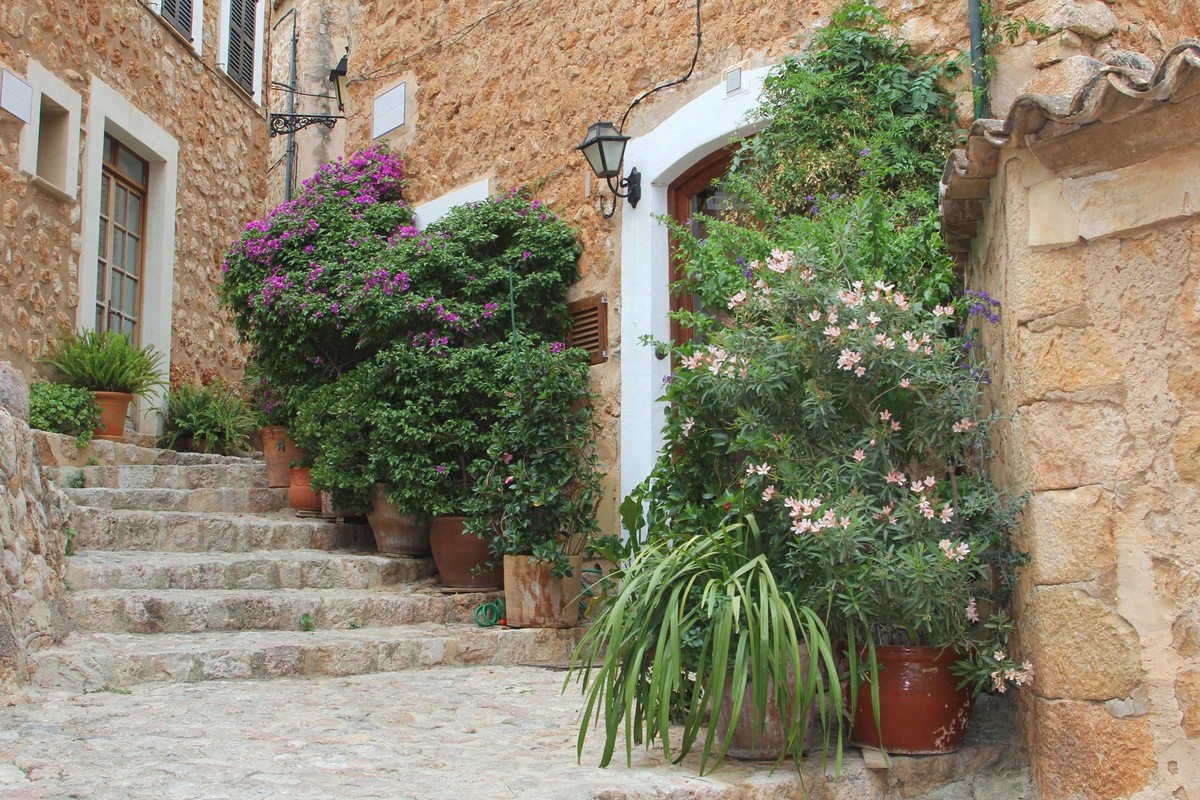 Rustic Mediterranean village Fornalutx, Mallorca, Spain, Rustic street with plants and flowers in the little Mediterranean village Fornalutx in the Tramuntana mountains at the isle of Mallorca, Spain. ...