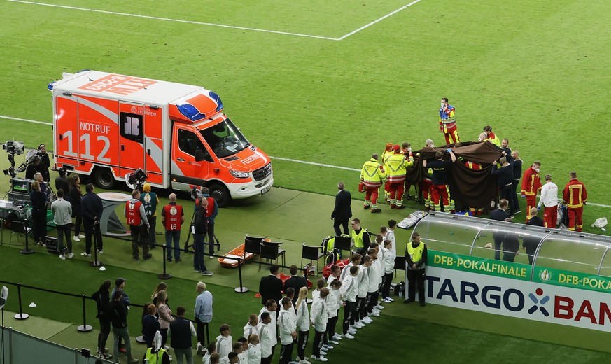 BERLIN, GERMANY - MAY 21: An ambulance reports to a medical emergency by the side of the pitch before the RB Leipzig lift the trophy following the final match of the DFB Cup 2022 between SC Freiburg a ...