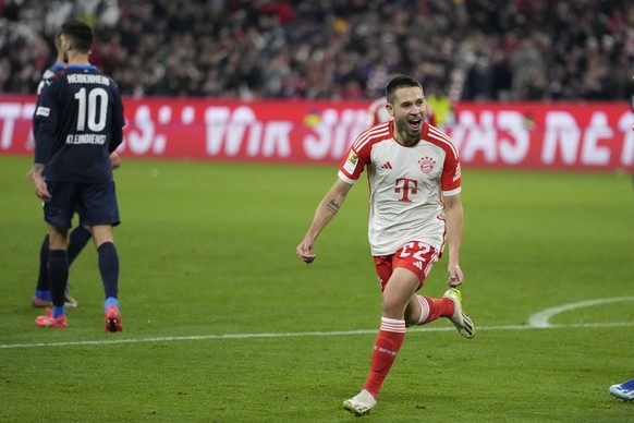 Bayern&#039;s Raphael Guerreiro celebrates after scoring his side&#039;s third goal during the German Bundesliga soccer match between Bayern Munich and Heidenheim at the Allianz Arena stadium in Munic ...