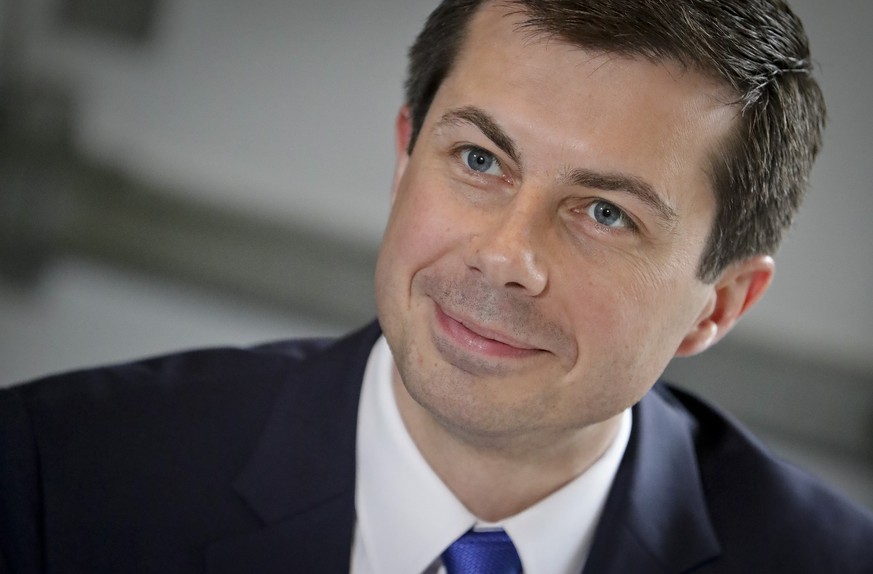 FILE - In this April 29, 2019 file photo, then Democratic presidential candidate Mayor Pete Buttigieg, from South Bend, Indiana, listens during a lunch meeting with civil rights leader Rev. Al Sharpto ...