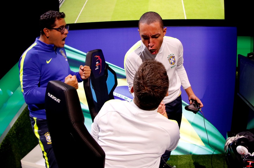 Esports - The FIFA eNations Cup - Maidstone, Kent, Britain - April 13, 2019 Ebio 'Ebinhob' Bernardes of Brazil and Victor 'Tore' Coelho of Brazil celebrate during day one REUTERS/Tom Jacobs