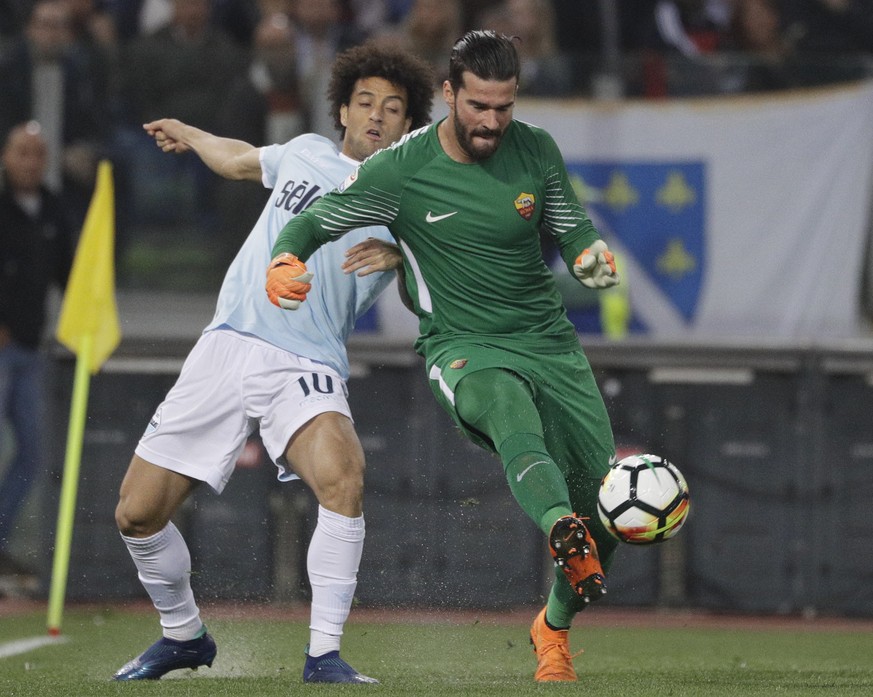 Roma goalkeeper Alisson, right, and Lazio&#039;s Felipe Anderson vie for the ball during an Italian Serie A soccer match between AS Roma and Lazio, at the Olympic stadium in Rome, Sunday, April 15, 20 ...
