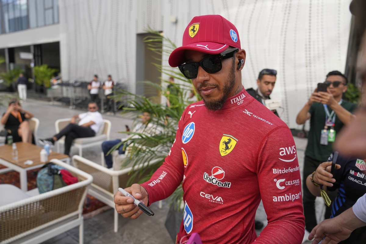 Ferrari driver Lewis Hamilton of Britain signs autographs I the paddock prior to the start of the third free practice ahead of the Formula One Saudi Arabian Grand Prix at the Jeddah Corniche Circuit i ...