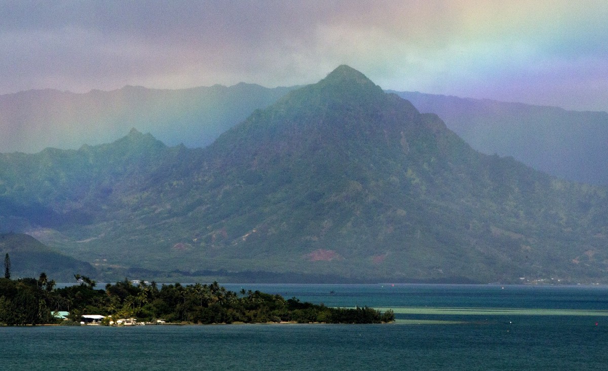 FILE -A rainbow is seen in the sky from President Barack Obama&#039;s motorcade as it passes Kaneohe Bay heading for the beach at Bellows Air Force Station, Saturday, Jan. 3, 2015, on the island of Oa ...