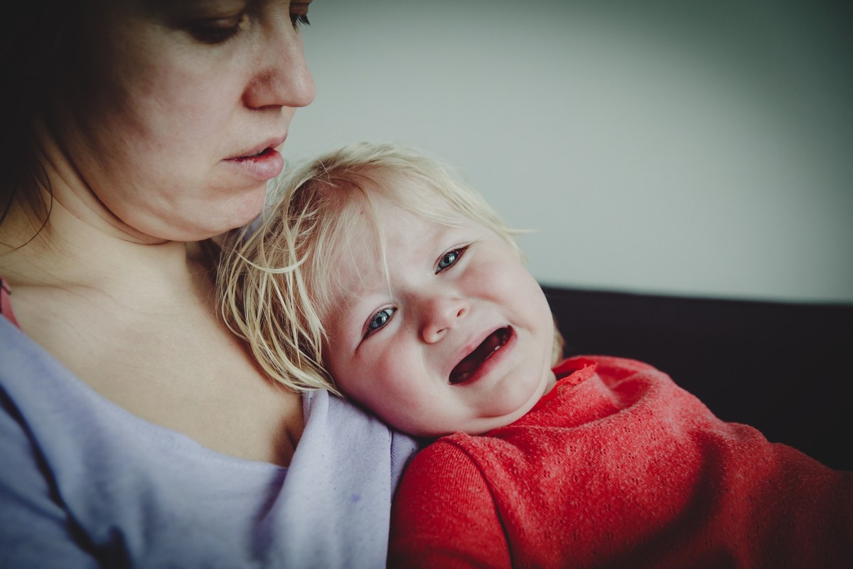 Mother comforting crying little baby, parenting and care conceptMother comforting crying little baby, parenting and care concept