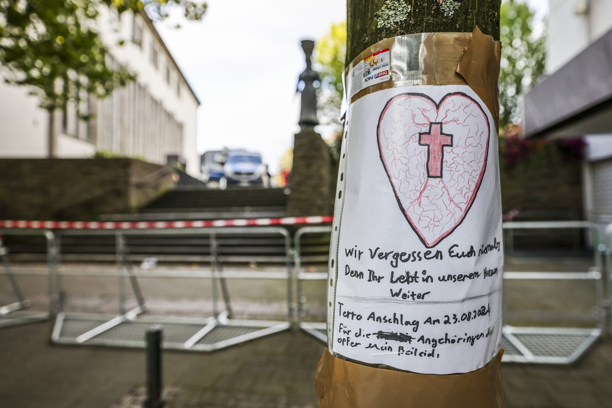 24.08.2024, Nordrhein-Westfalen, Solingen: Nach der Messerattacke auf dem Solinger Stadtfest h�ngt ein selbstgeschriebenes Beileidsschreiben mit einem Herz und einem Kreuz an einem Baum in der N�he de ...