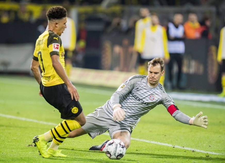 Du kommst nicht vorbei! Bayern-Torwart Manuel Neuer (r.) im Duell mit BVB-Youngster Jadon Sancho. Ob sie in der Bundesliga bleiben scheint derzeit ungewiss.