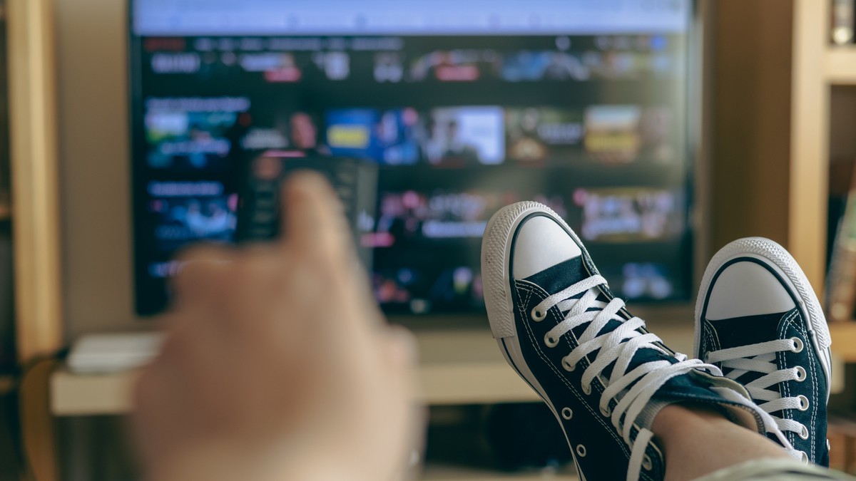 Relaxed Person At Home Watching TV. Video Streaming Concept